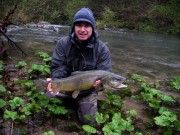 Jeremy and his trophy Marble trout in rain